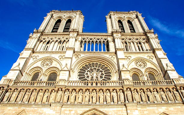 Notre-Dame Cathedral facade in Paris with detailed sculptures and rose window.