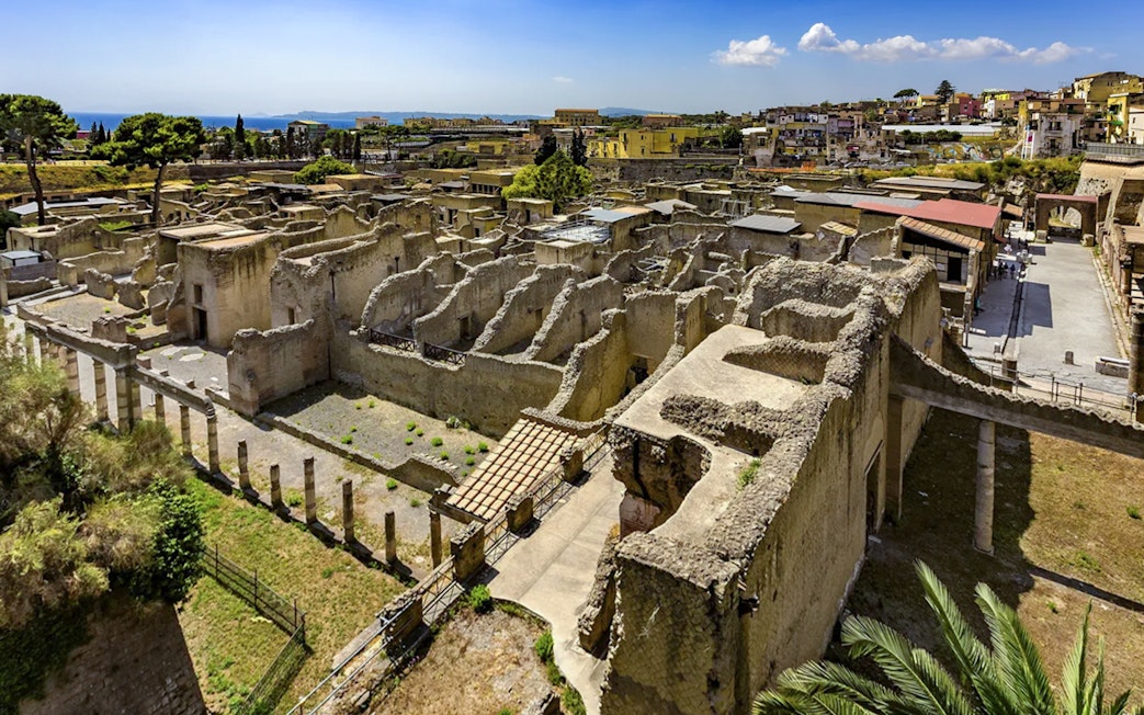 Ancient ruins of Herculaneum with surrounding landscape, view from above.