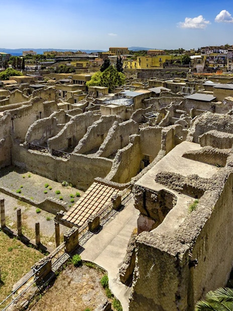 Ancient ruins of Herculaneum with surrounding landscape, view from above.