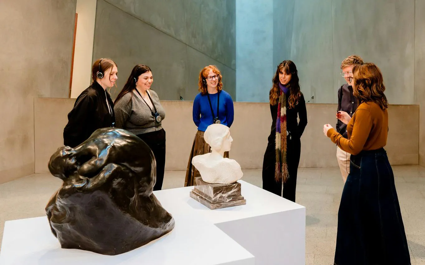 Visitors on a guided tour at the National Gallery of Victoria viewing sculptures.