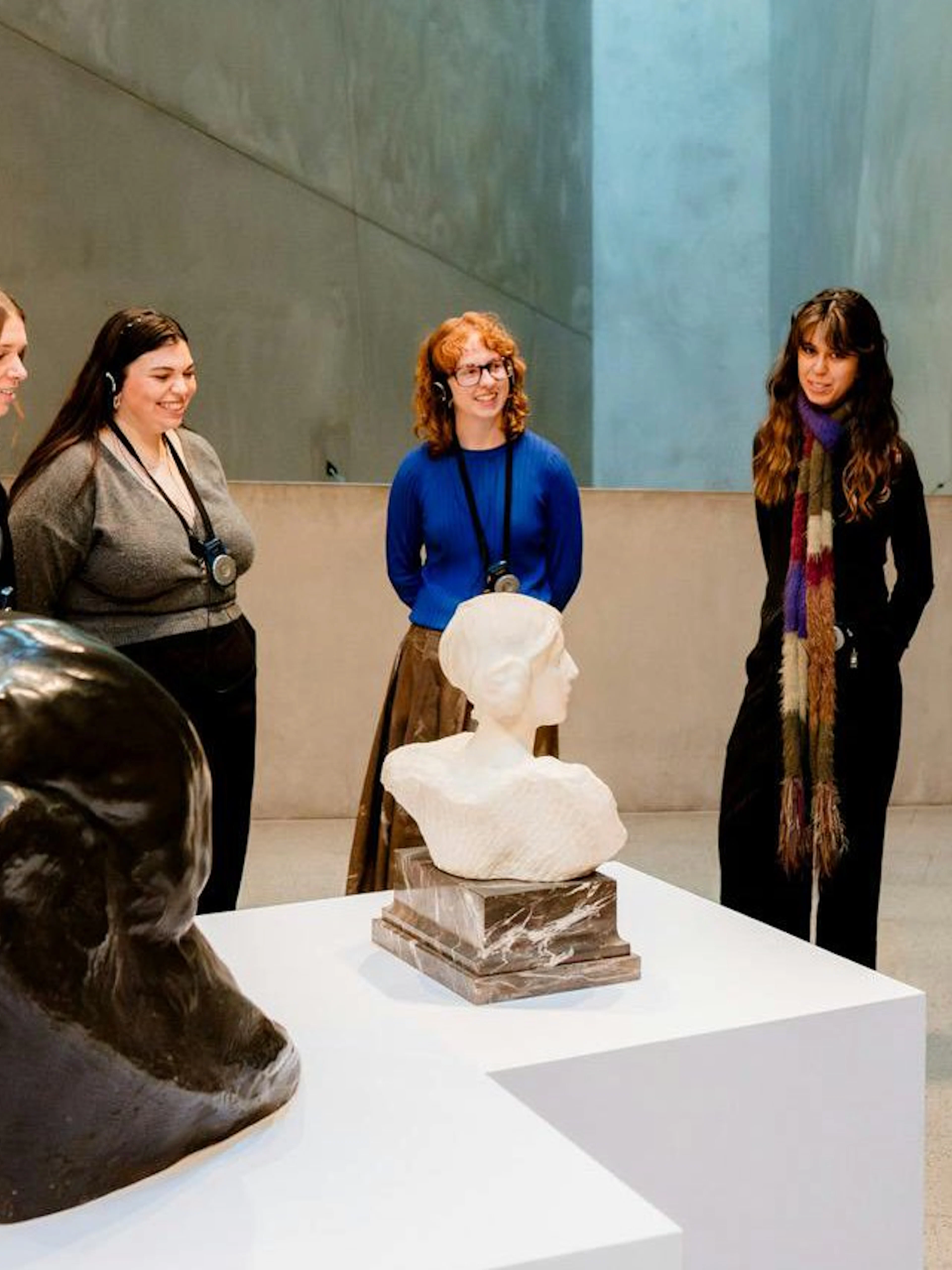 Visitors on a guided tour at the National Gallery of Victoria viewing sculptures.