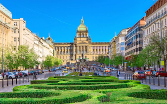 Wenceslas Square in Prague with National Museum and bustling street.