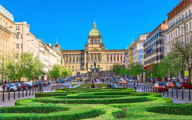 Wenceslas Square in Prague with National Museum and bustling street.