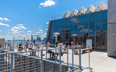 Outdoor balcony terraces at the Whitney Museum with visitors enjoying the view.