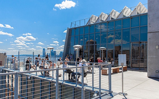 Outdoor balcony terraces at the Whitney Museum with visitors enjoying the view.