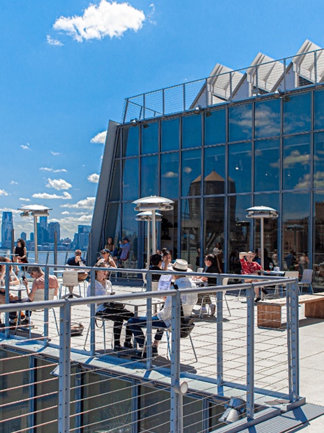 Outdoor balcony terraces at the Whitney Museum with visitors enjoying the view.