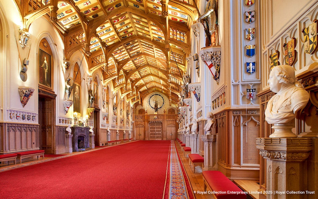 Windsor Castle interior with ornate ceiling, red carpet, and historical busts.
