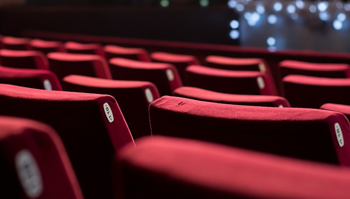 Rows of red theater seats in a West End venue.