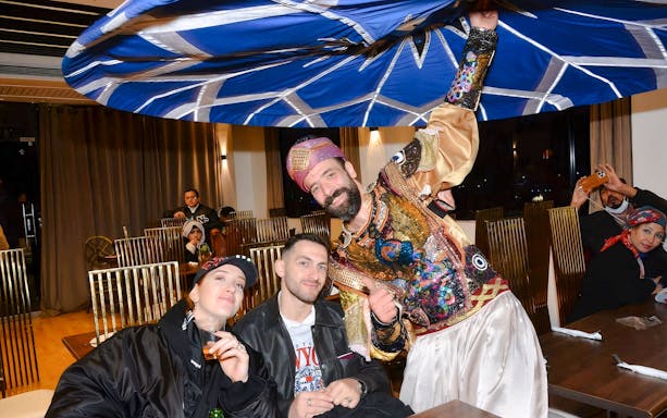 Guests with performer on Nile Dinner Cruise in Cairo.