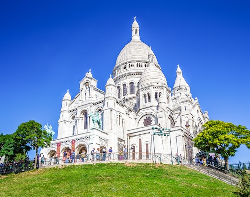 Montmartre street view with Sacré Coeur Basilica in the background, Paris.