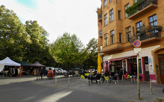 Street cafe and market stalls in Kreuzberg, Berlin during a guided food tour.