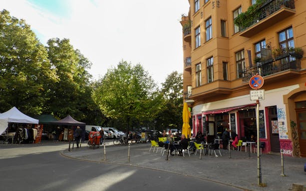 Street cafe and market stalls in Kreuzberg, Berlin during a guided food tour.