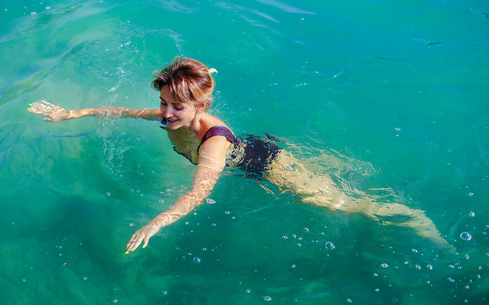 Guest swimming in Komani Lake during day trip from Tirana.