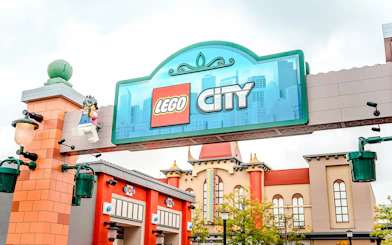 Entrance to Lego City at Legoland Japan with colorful buildings in the background.