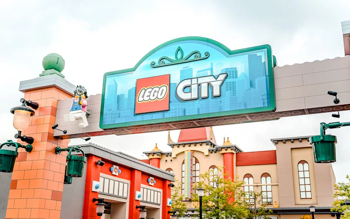 Entrance to Lego City at Legoland Japan with colorful buildings in the background.
