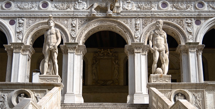 Staircase of the Doge Palace in Venice with ornate marble steps and intricate ceiling details.