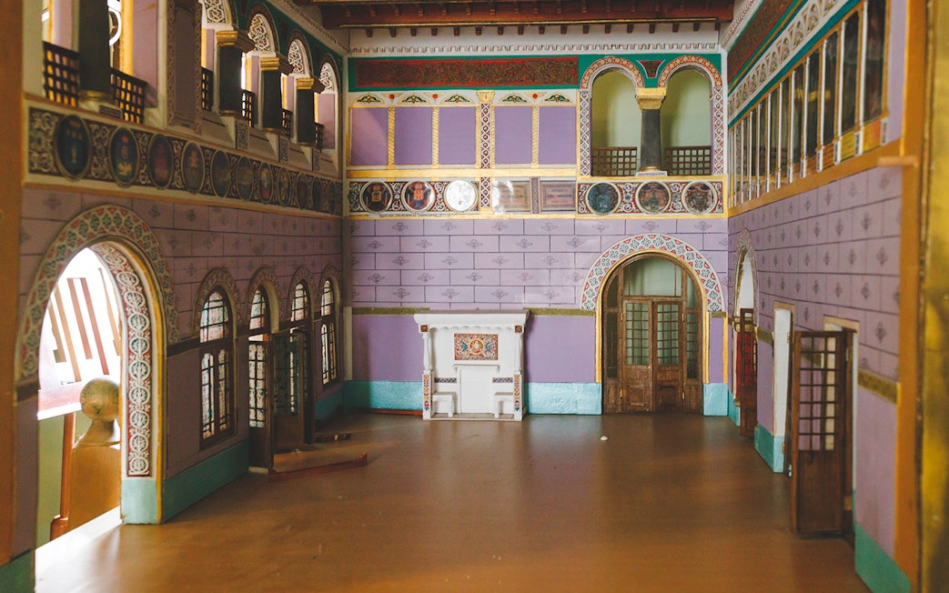 Grand room with ornate arches and colorful walls at Peles Castle, Romania.