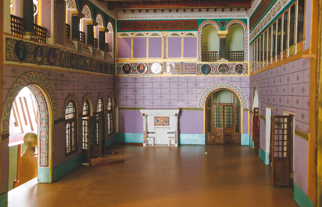 Grand room with ornate arches and colorful walls at Peles Castle, Romania.