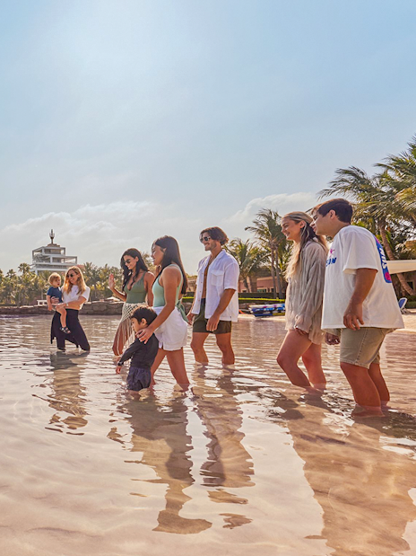 Tourists interacting with dolphins at Atlantis, The Palm, Dubai.