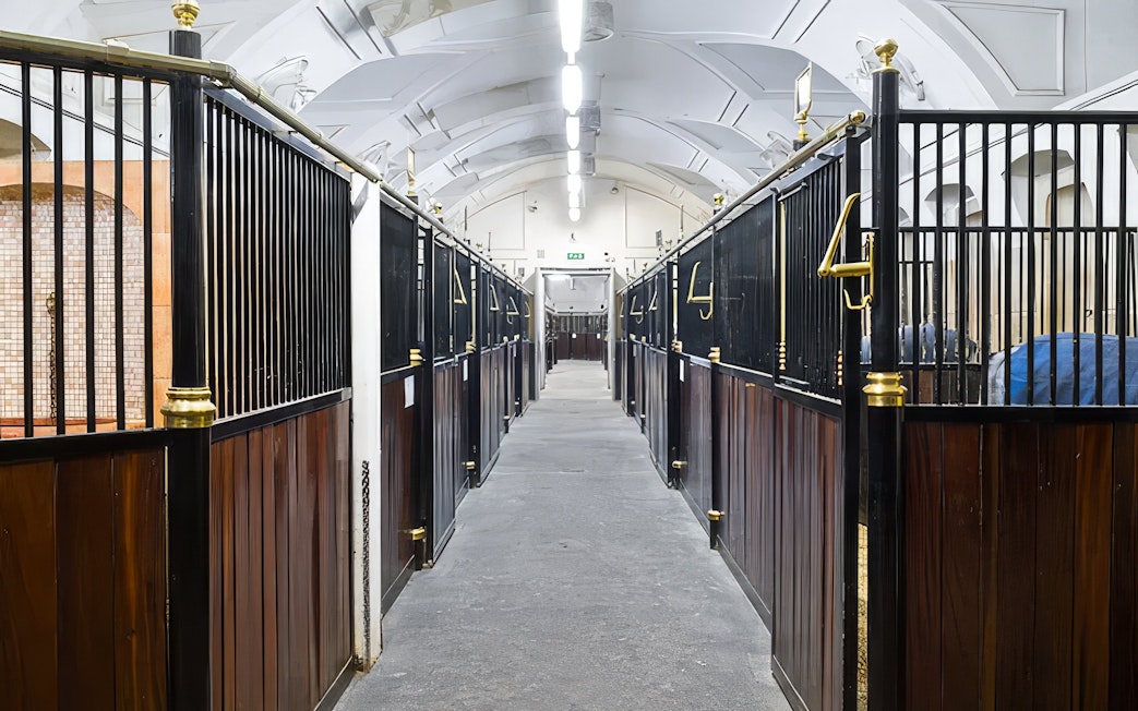 Stallburg Imperial Stables interior with rows of horse stalls in Vienna.