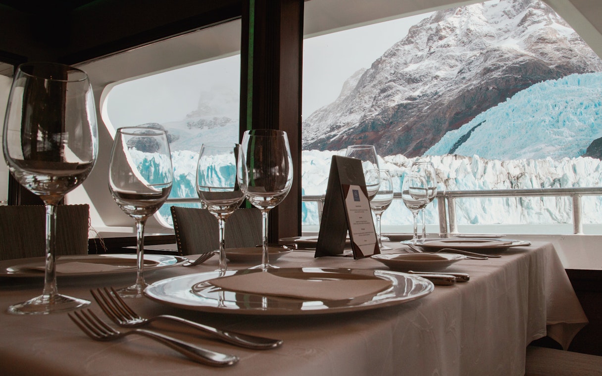 Dining setup on boat with glacier view during Spirit of the Glaciers tour.