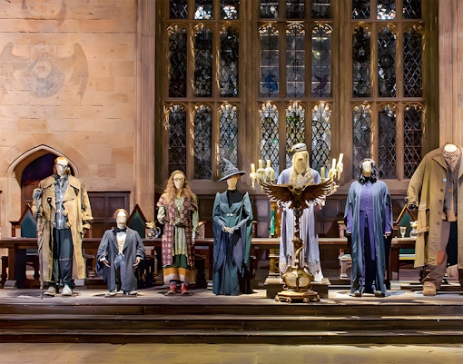 Costume exhibit at Harry Potter London tour showcasing iconic wizard robes.