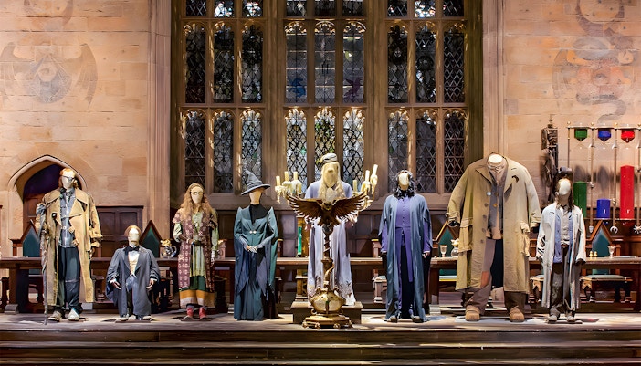 Costume exhibit at Harry Potter London tour showcasing iconic wizard robes.
