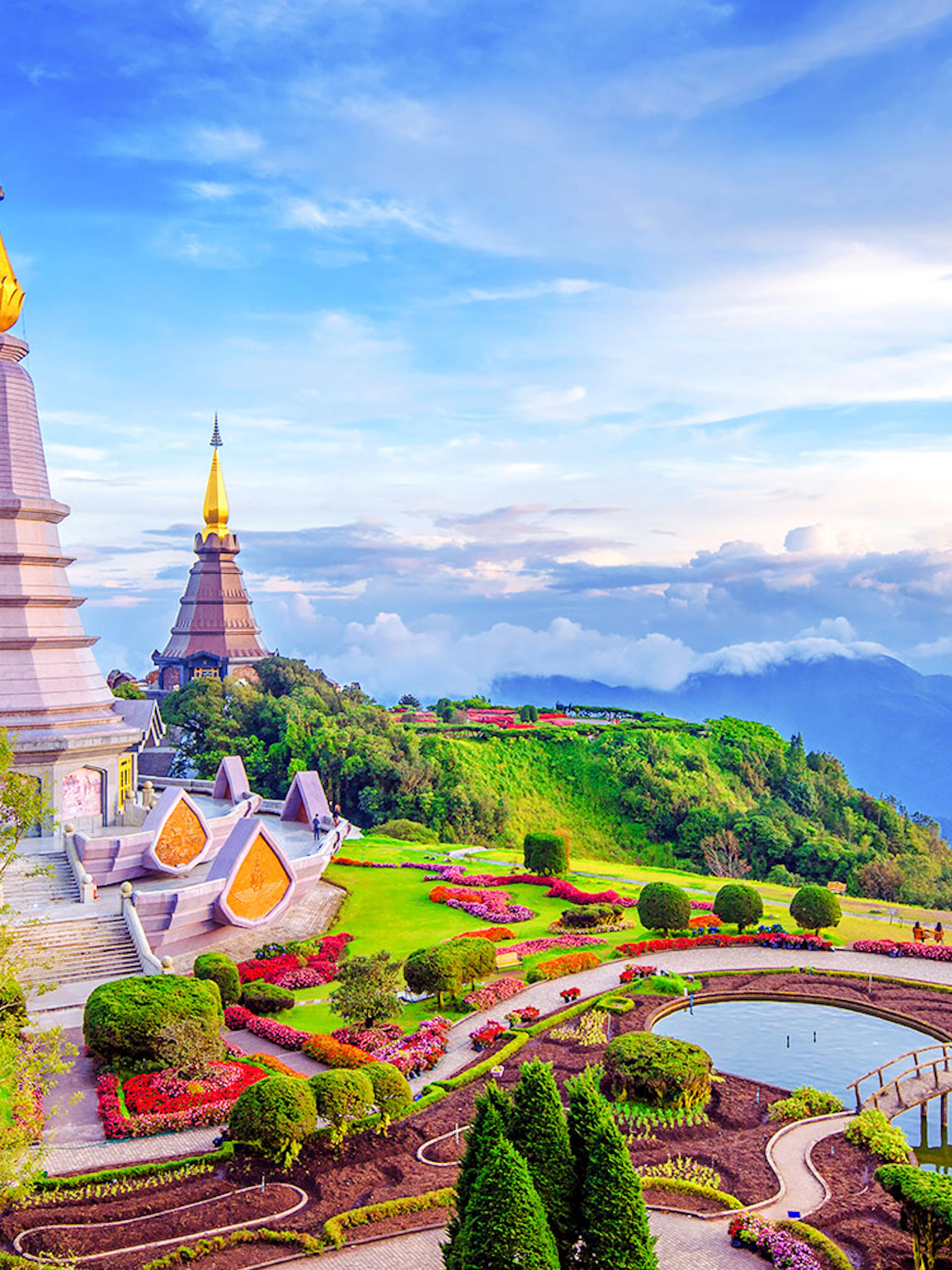 Twin pagodas at Doi Inthanon, Chiang Mai, surrounded by lush gardens and mountain views.
