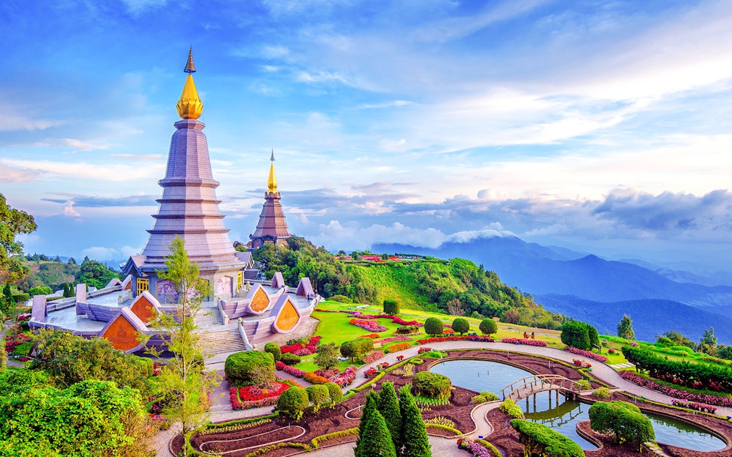 Twin pagodas at Doi Inthanon, Chiang Mai, surrounded by lush gardens and mountain views.