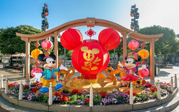 Mickey Mouse parade float at Disneyland Hong Kong with Sleeping Beauty Castle in the background.