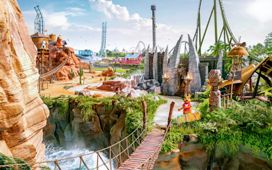 Panoramic view of Walibi Belgium park with roller coasters and lush greenery.