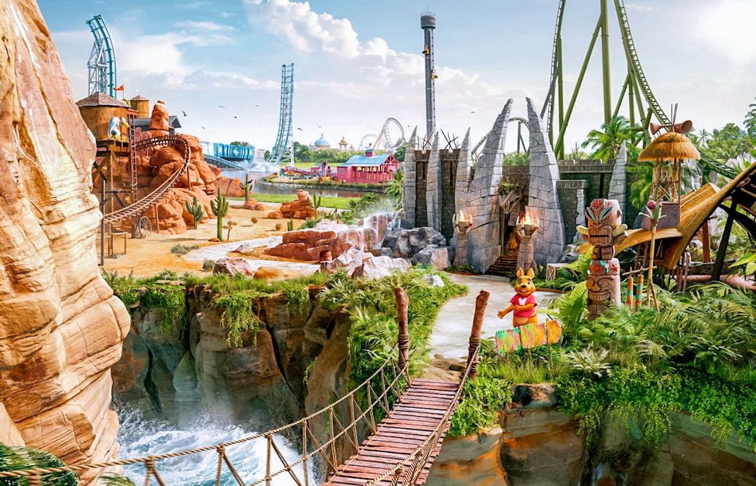 Walibi Belgium park panoramic view with roller coasters and lush greenery.