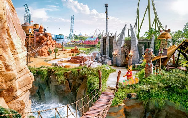 Panoramic view of Walibi Belgium park with roller coasters and lush greenery.