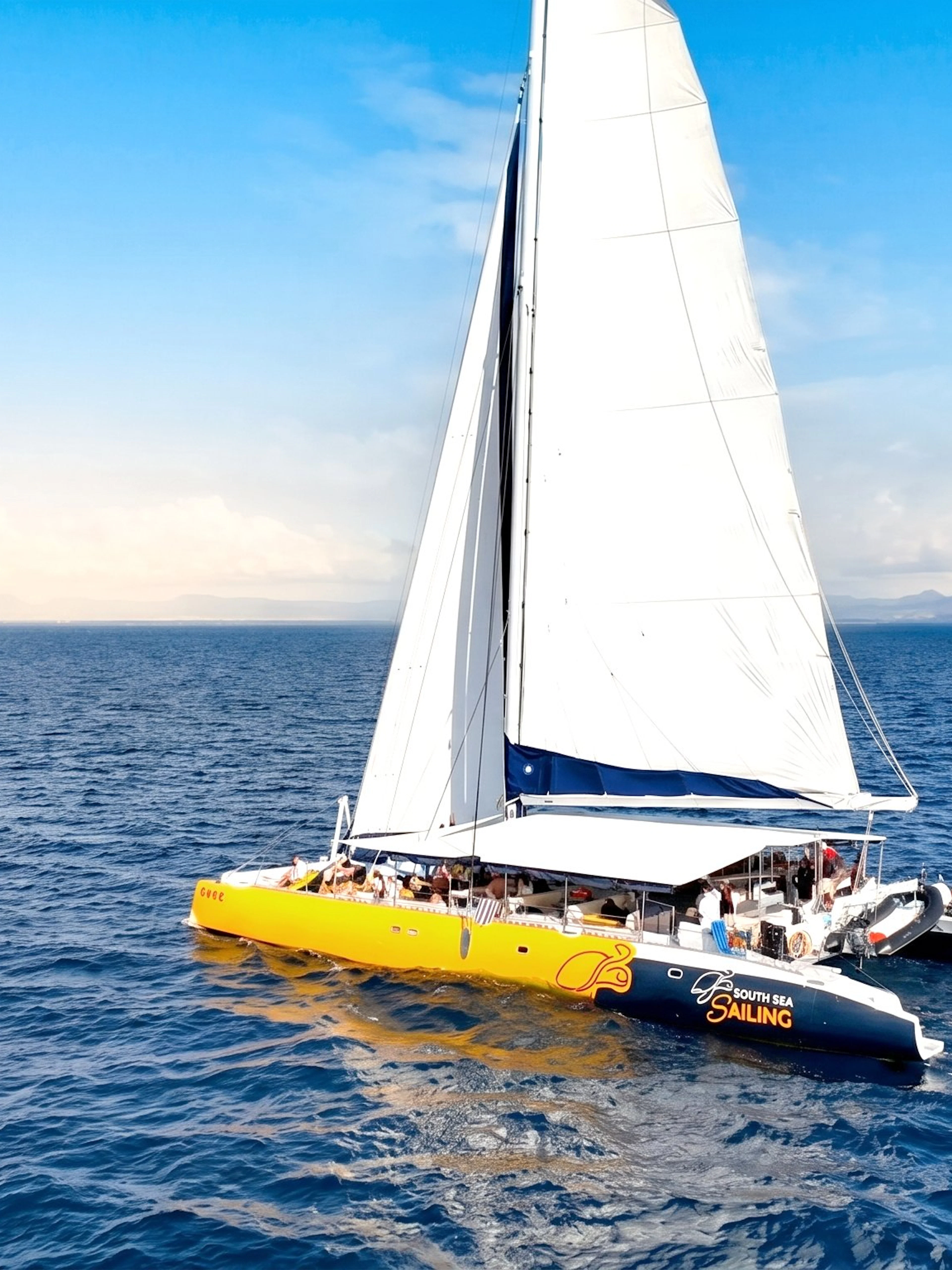 Catamaran sailing on ocean during Sabre Sunset Cruise with BBQ dinner and drinks.