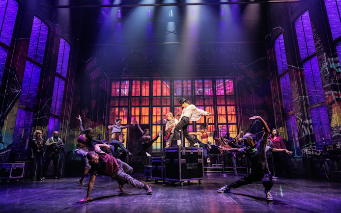 Performers dancing energetically on stage during MJ the Musical on Broadway.