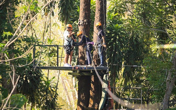Participants preparing for a zipline adventure in Phuket's lush forest.