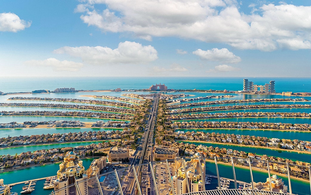 Aerial view of Palm Jumeirah in Dubai with Atlantis Hotel in the distance.