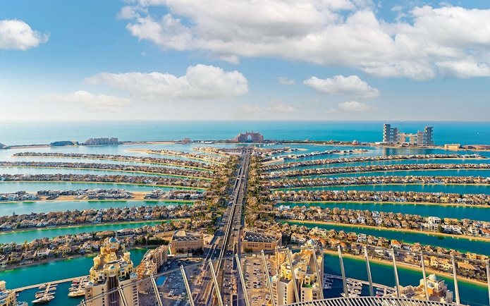 Aerial view of Palm Jumeirah in Dubai with Atlantis Hotel in the distance.