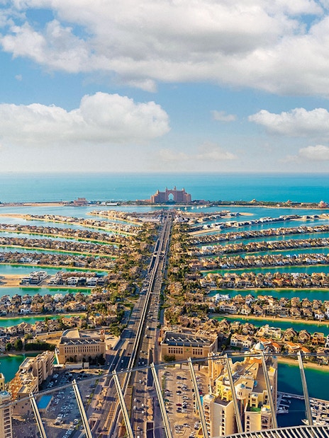 Aerial view of Palm Jumeirah in Dubai with Atlantis Hotel in the distance.