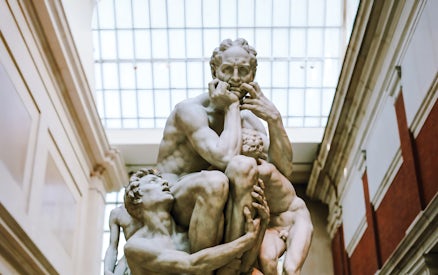Ugolino and His Sons sculpture by Jean-Baptiste Carpeaux in a museum setting.
