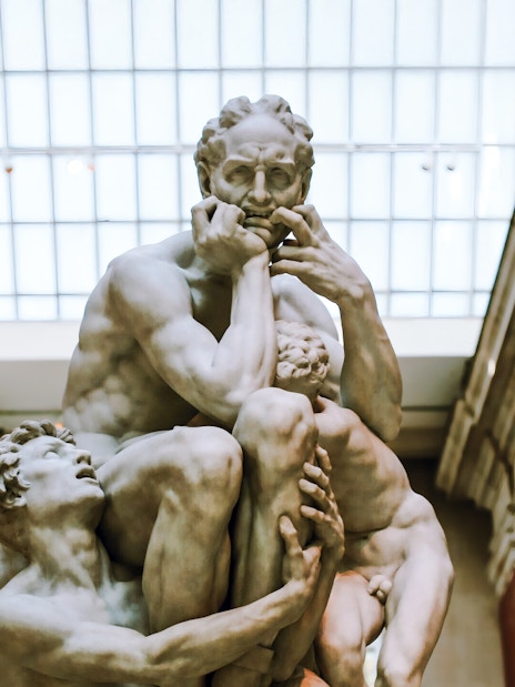 Ugolino and His Sons sculpture by Jean-Baptiste Carpeaux in a museum setting.