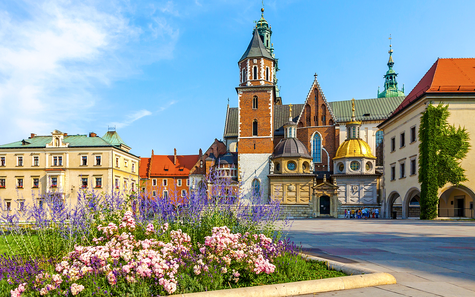 Wawel Cathedral with colorful flowers in the foreground, Kraków, Poland.