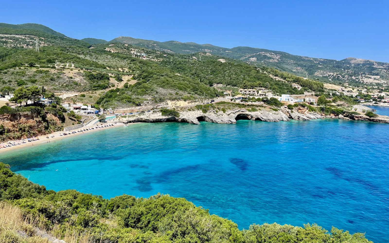 Makris Gialos Beach with clear blue waters and surrounding hills on Zakynthos north coast.