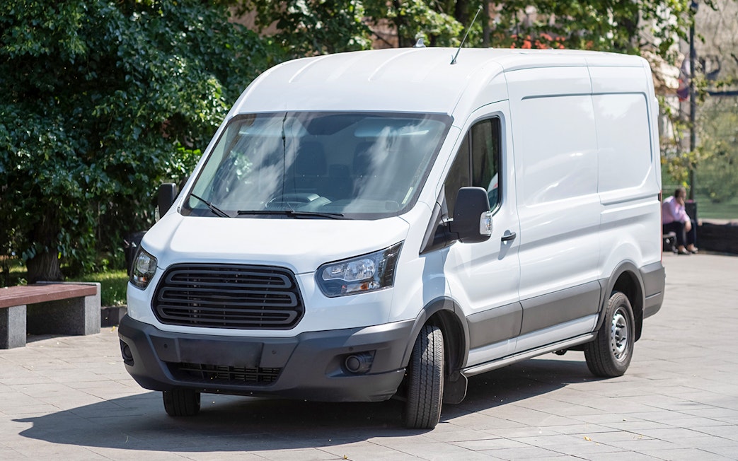 Minibus parked on a city street for transfer services.