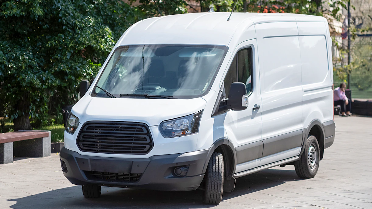 Minibus parked on a city street for transfer services.
