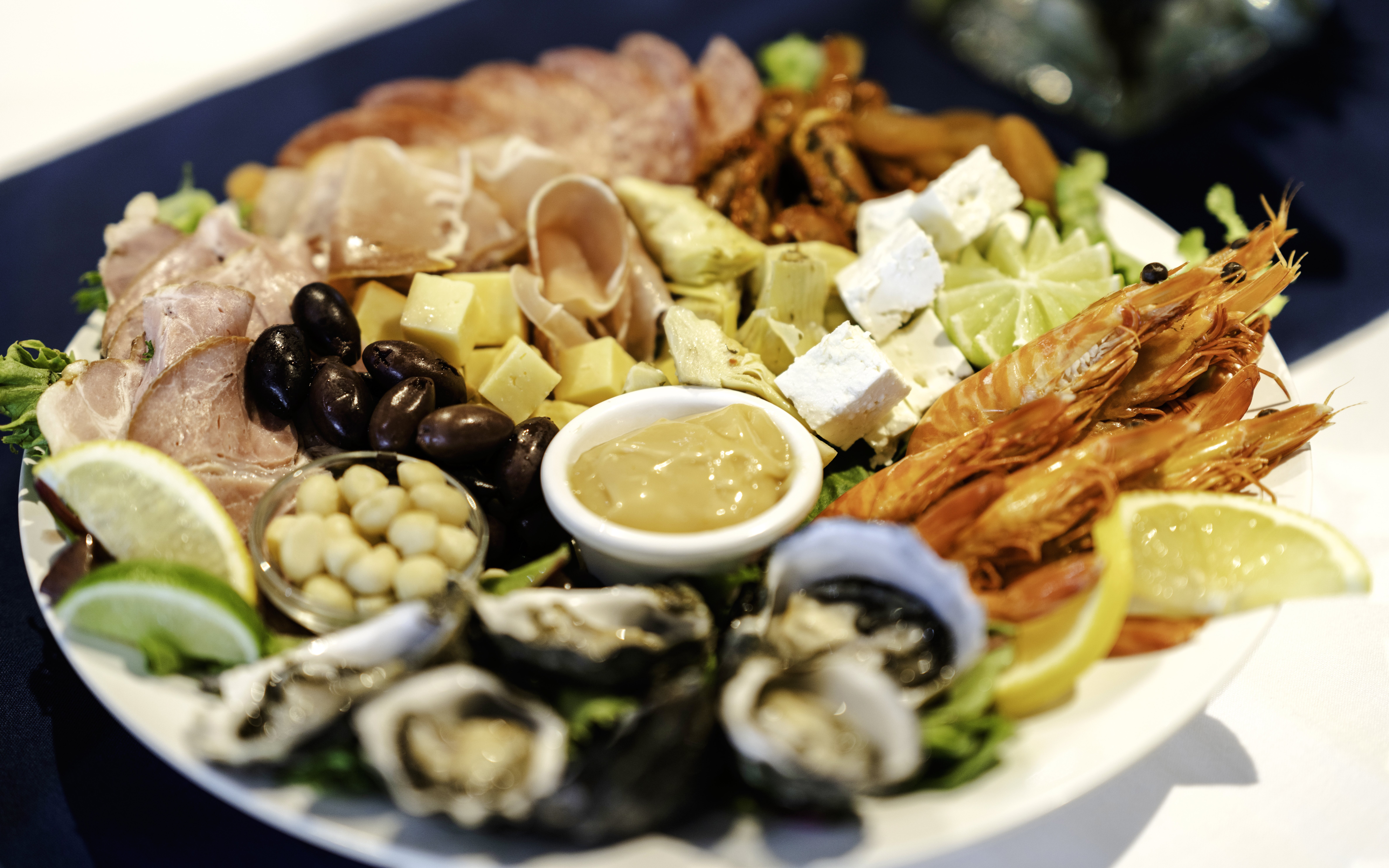 Seafood platter with prawns, oysters, cheese, and olives on Darwin Harbour Sunset Dinner Cruise.