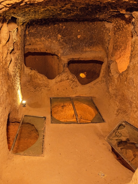 Ozkonak underground city chamber with stone walls and ventilation holes.