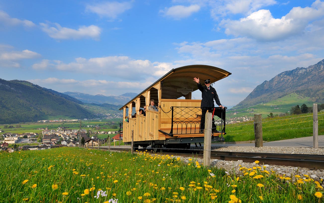 Open-air train on Mount Stanserhorn day trip from Zürich, with scenic mountain views.