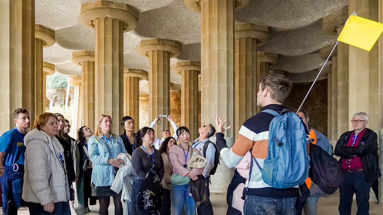 Tour group with guide in the hypostyle hall of Park Güell, Barcelona.