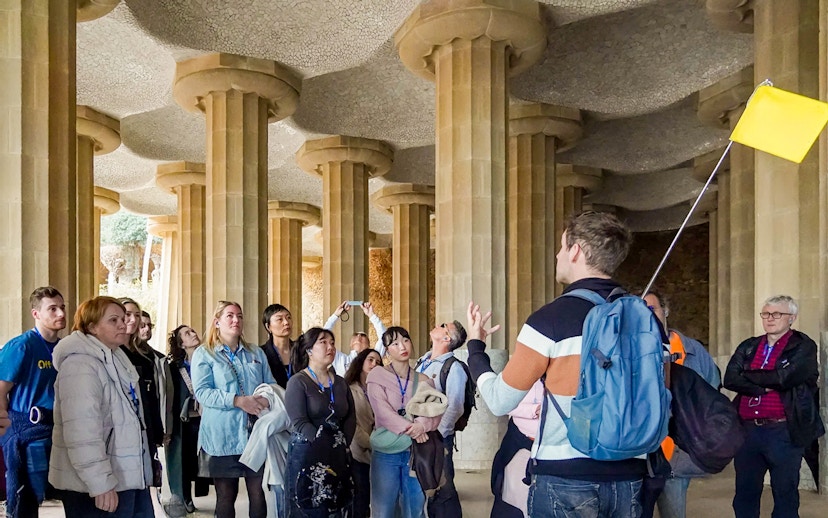 Tour group with guide in the hypostyle hall of Park Güell, Barcelona.